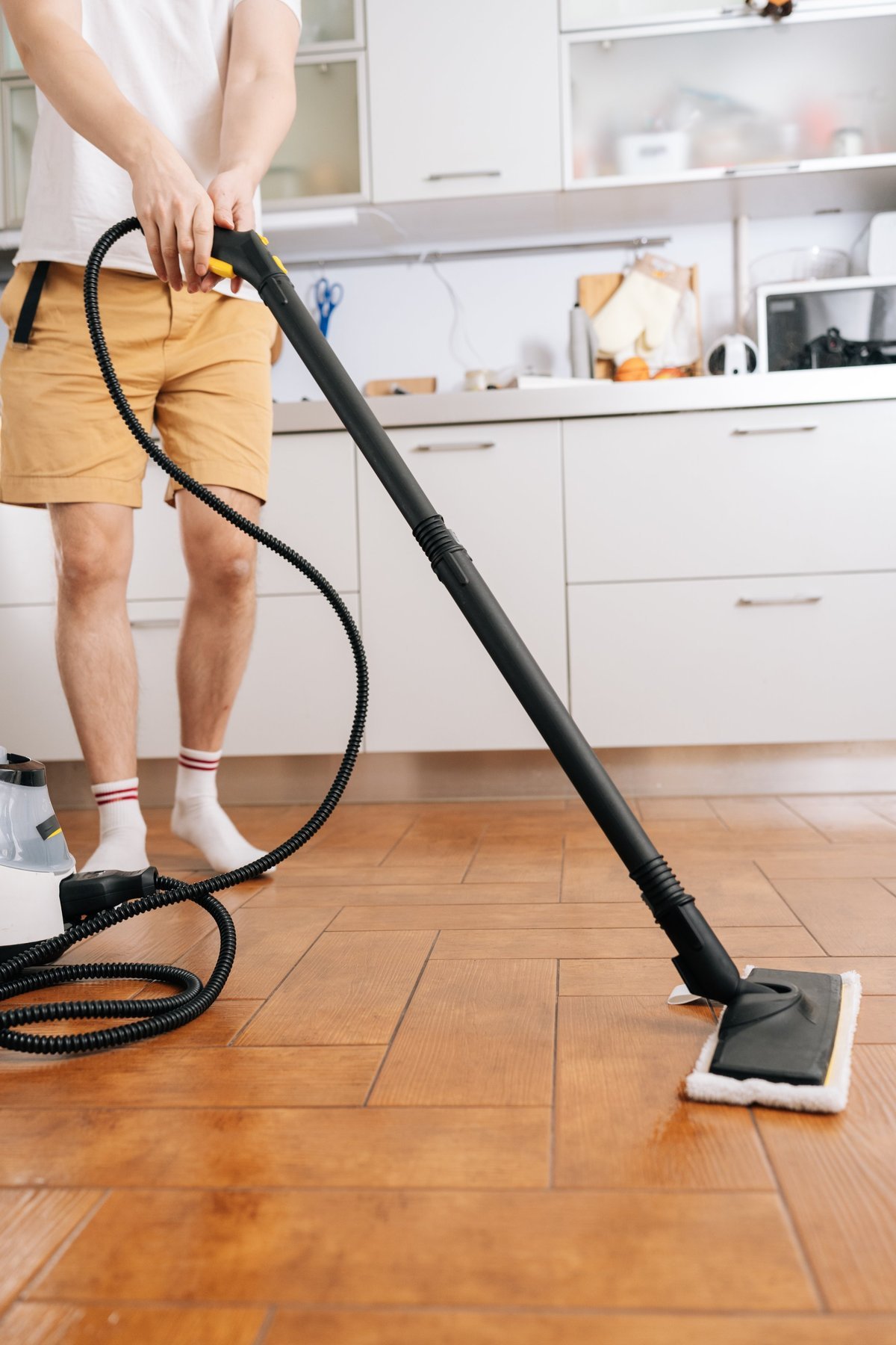Professional cleaner using equipment to deep clean a floor